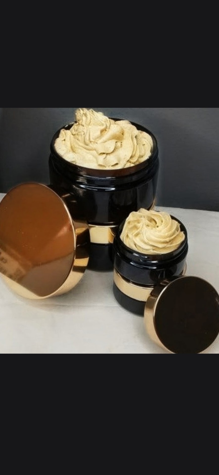 Two jars of whipped body butter with rose-gold lids